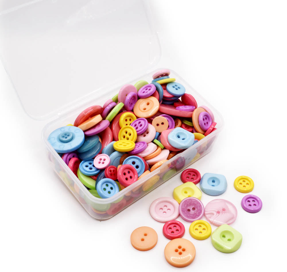 Assortment of sewing buttons in pastel rainbow tones in various sizes and styles.