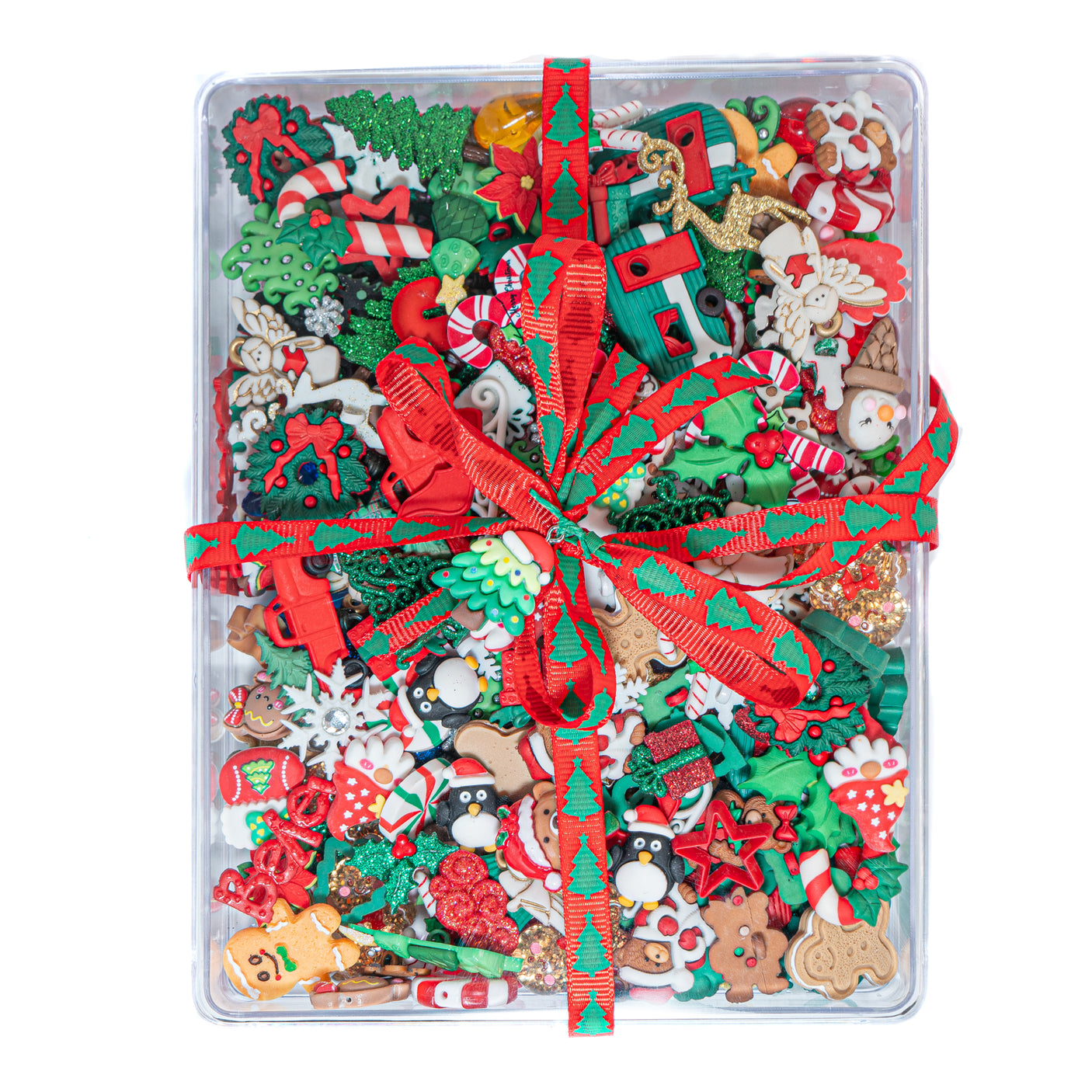 Assorted Christmas-themed decorative items in a clear container with a red ribbon.