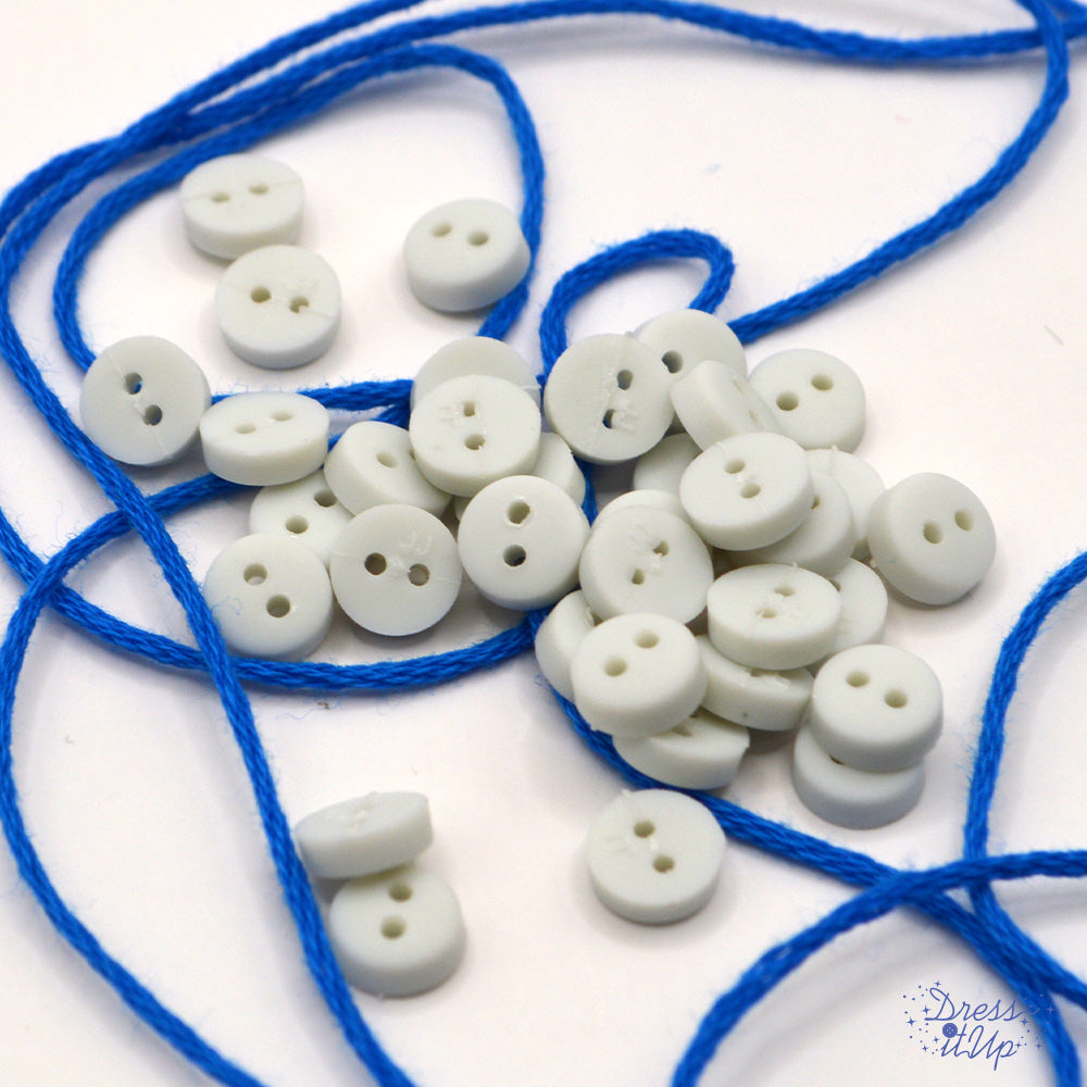 6mm round white buttons on a white background. Buttons made for sewing projects.