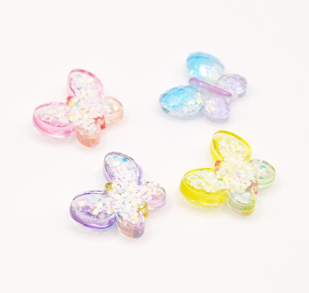 Flat back resin craft embellishments in the shape of glitter filled butterflies