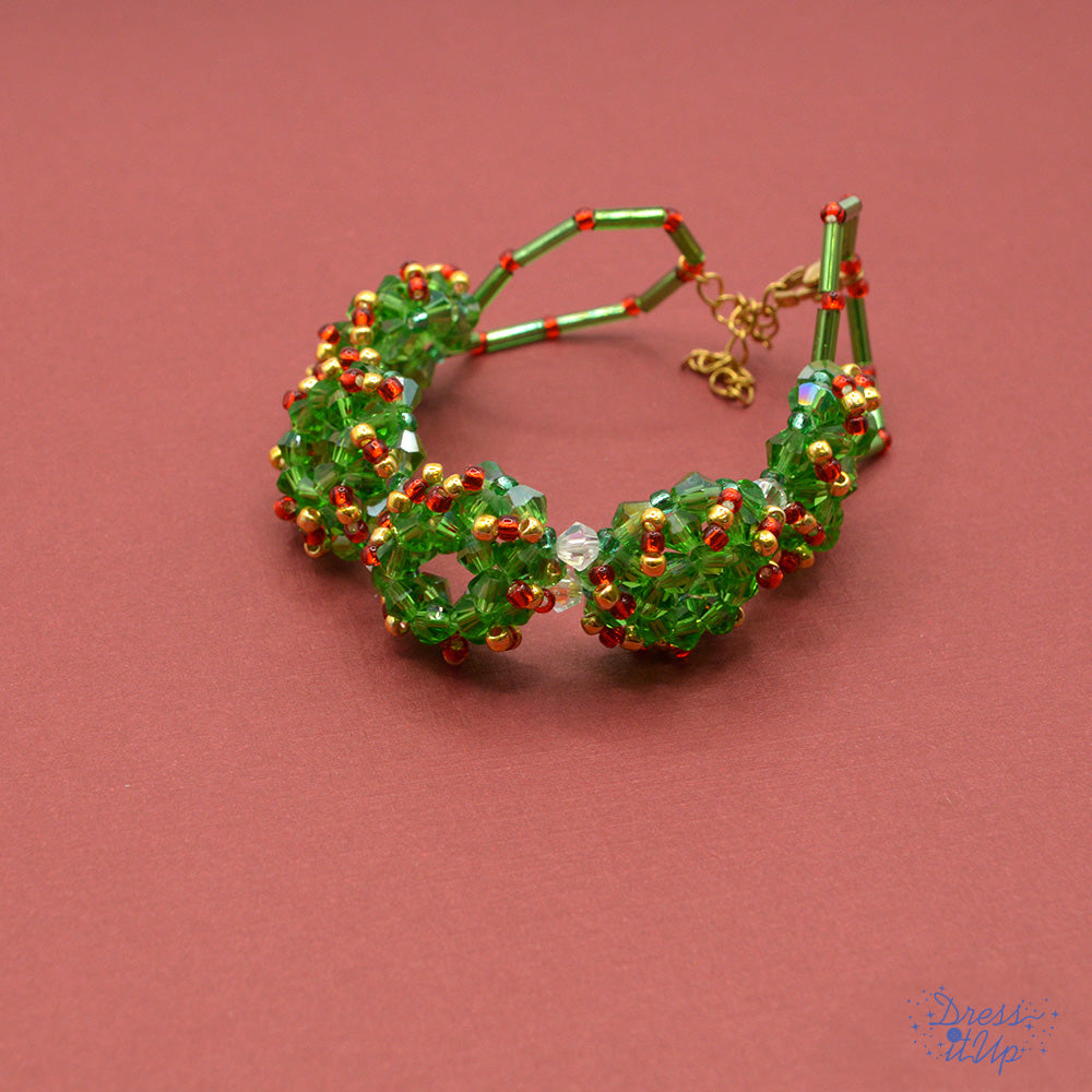 Featuring alloy enamel holly leaves and vibrant red and green accents