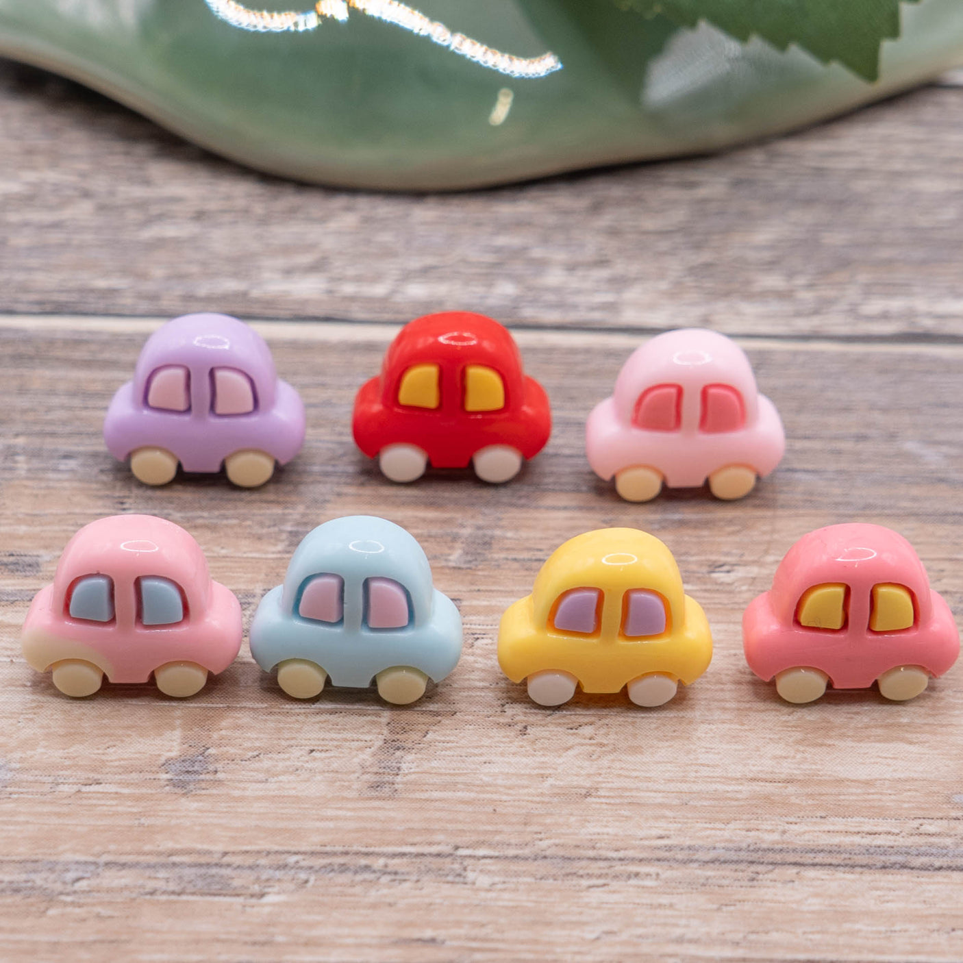 pastel car craft embellishments on wood background