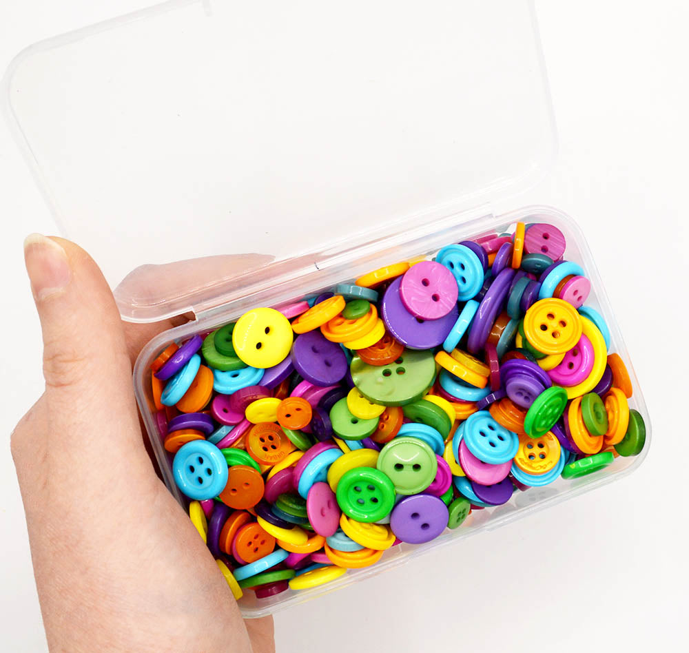 Assortment of sewing buttons in bright jewel tones in various sizes and styles.