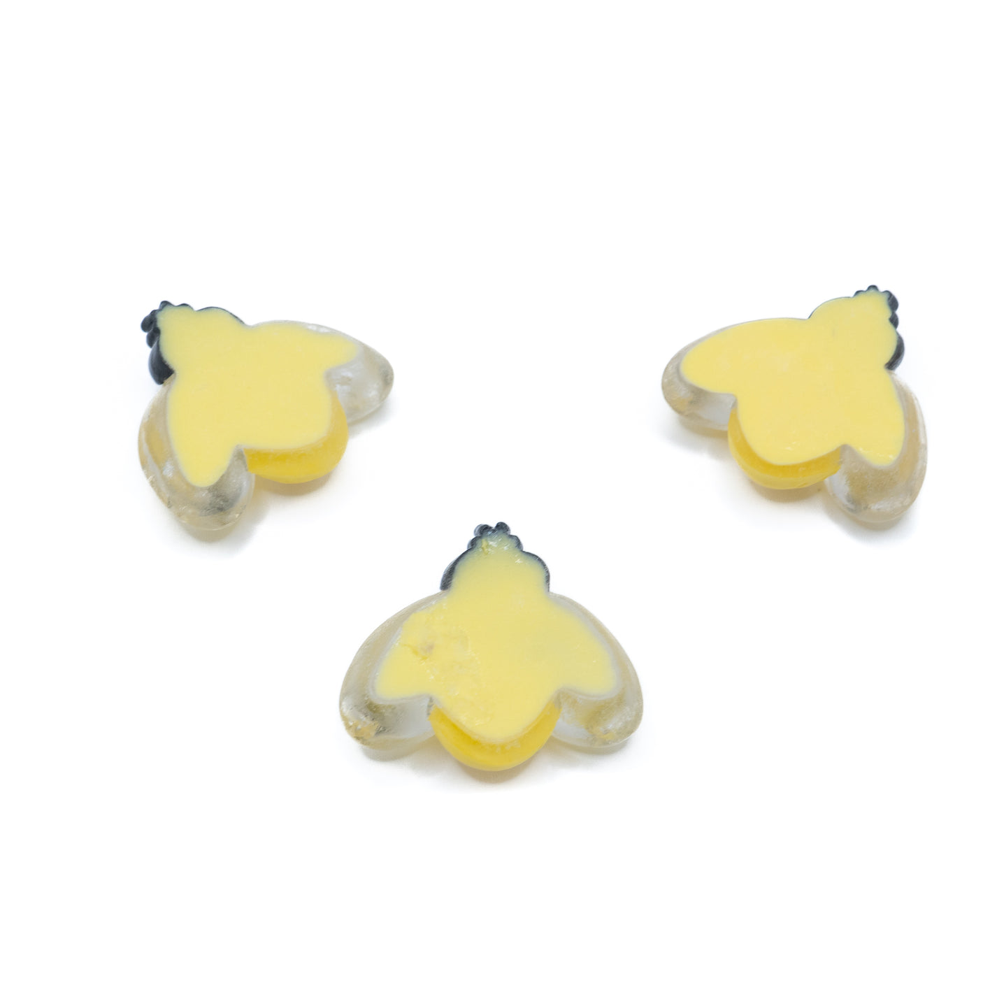A pack of large resin bees in a mild yellow color for diy crafts