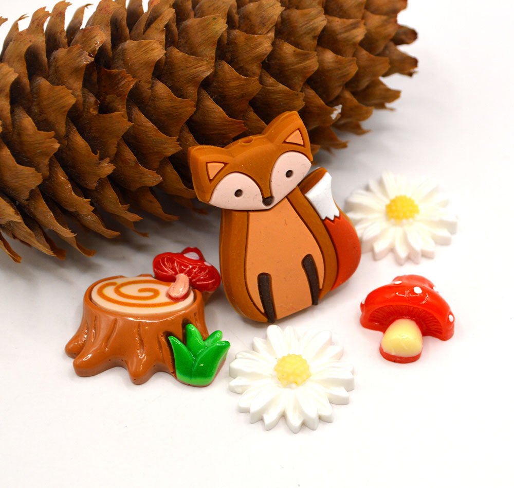 A large silicone fox bead and resin flat back woodland themed embellishments.