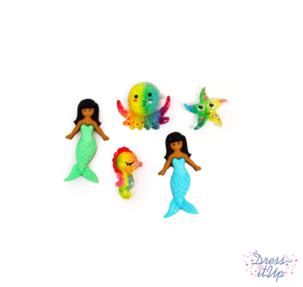 Two elegant mermaids and three resin sea creatures in rainbow colors add to ocean inspired crafting