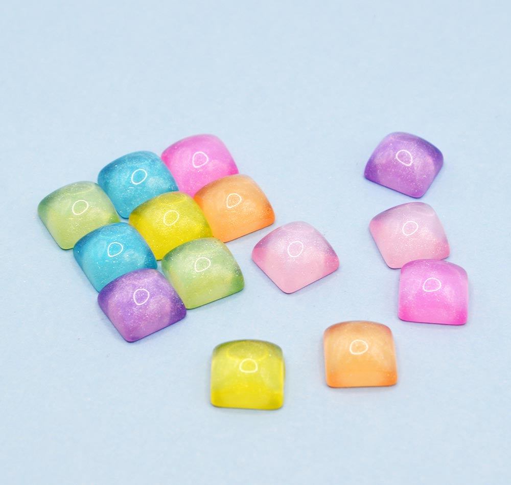 Featuring colorful squares with a glossy jelly-like finish, these embellishments are perfect for DIY crafting, scrapbooking, and decorating accessories.