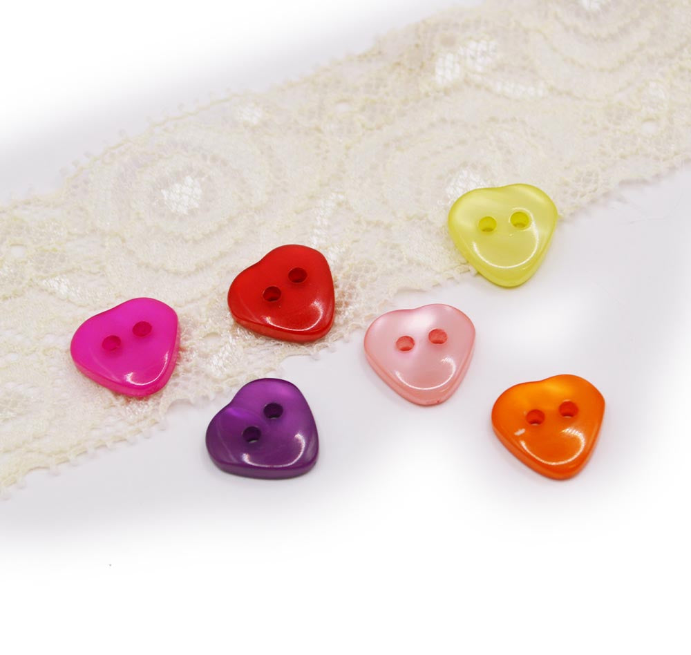 two-hole heart buttons with a pearlized finish in bright colors.