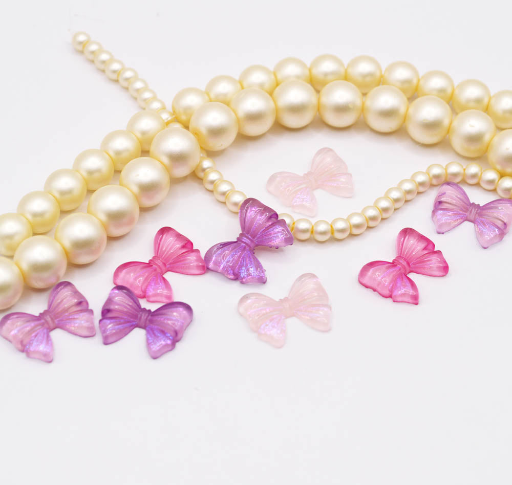 pink and purple flat back hair bow shaped craft embellishments.