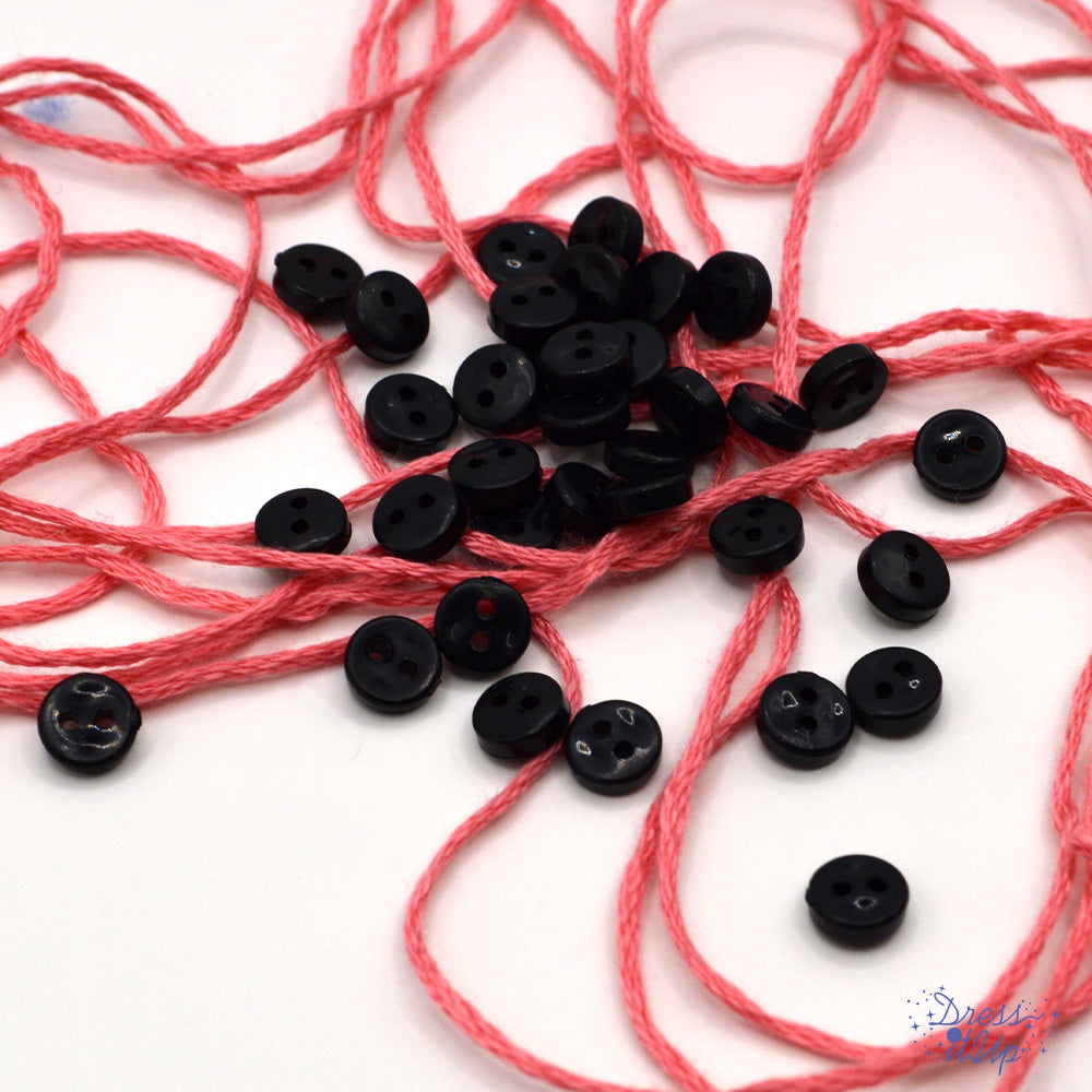 6mm round black buttons on a white background. Buttons made for sewing projects.