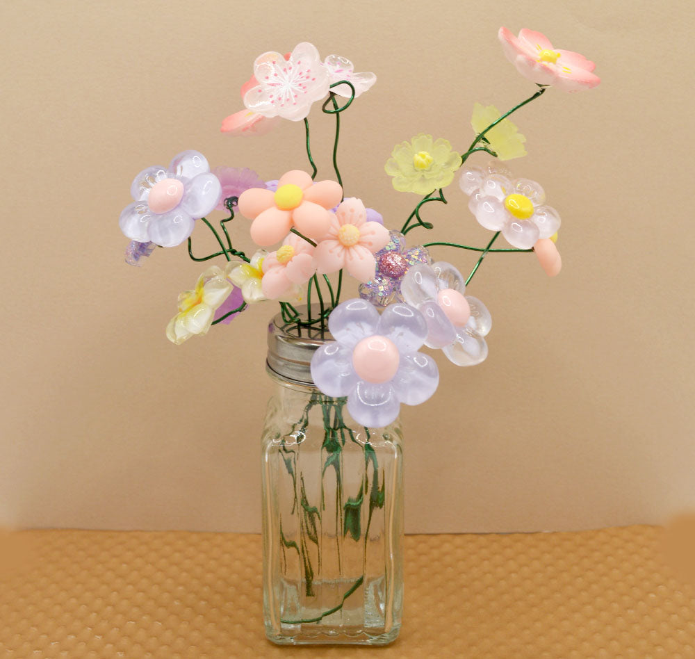 craft project of a salt shaker button bouquet featuring spring resin flowers.
