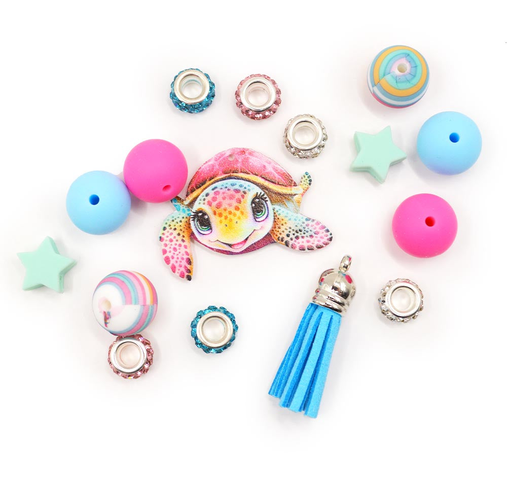 Assortment of silicone girl sea turtle themed beads with charms.