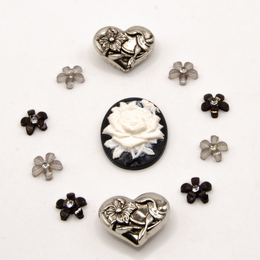 black, white, and silver metal vintage floral themed embellishment pack for crafting.