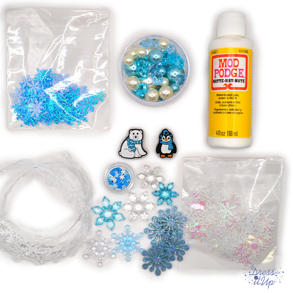 Create magical winter-themed crafts with the Winter Wonderland Craft Kit! This kit includes mod podge, snowflake ribbon trim, crystal snowflakes, and a variety of beads