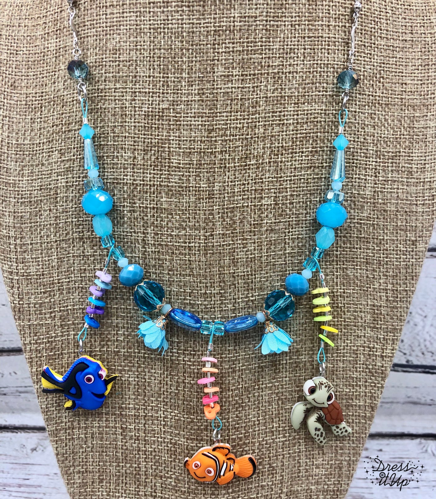 Nemo and friends from the Disney movie adorn this fun necklace