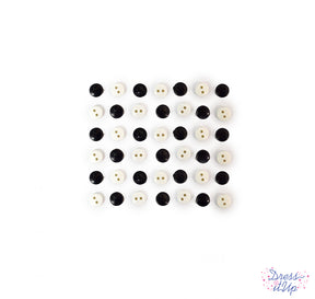 Tiny round sew-thru buttons in black and white for sewing and crafting