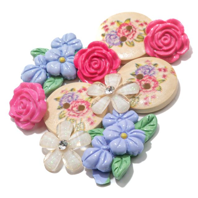Floral buttons and craft embellishments on white background