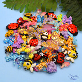 assortment of big and butterfly themed crafting embellishments