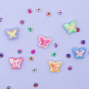 Bead assortment featuring pastel butterfly beads and small heishi beads with various floral prints.