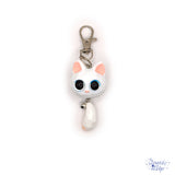 This white opaque Resin Kitten Keychain features a charming big-eyed cat with a playful bell
