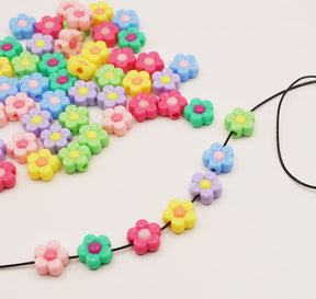 Plastic craft beads in bright flowers