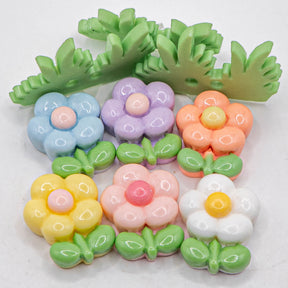 pastel resin flatback embellishments and grass buttons on white background