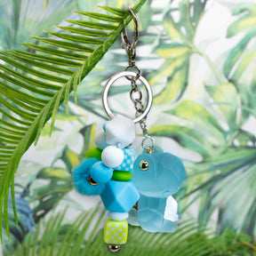 DIY keychain kit featuring large blue dinosaur, beadable keychain base and silicone  beads.