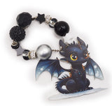 Assortment of silicone black and white dragon themed beads with charms. 