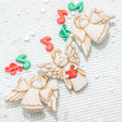 Craft buttons shaped like angels with musical notes on a textured white surface