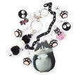 A black cat-themed keychain set featuring a large black and white cat charm, black paw prints with pink pads, a black-and-white fuzzy pom-pom, and small cat-shaped charms on silver key rings against a white background.