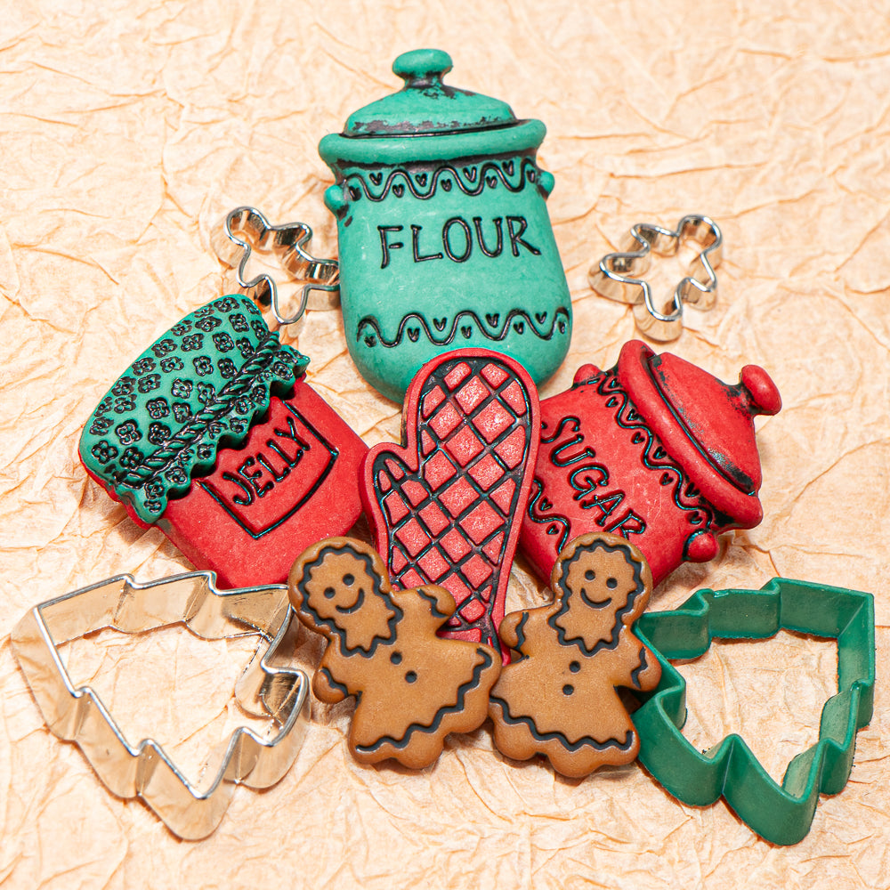 Set of plastic button jars labeled 'Flour', 'Jelly', 'Sugar' with corresponding cookie cutters on a textured beige background.