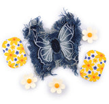 A denim butterfly-shaped patch with white thread detailing, surrounded by small daisy-shaped accessories on a white background.