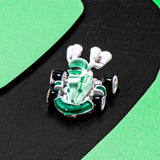 A small white and green go-kart toy with black wheels, photographed on a black surface with bright green curved shapes in the background.