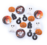A set of Halloween-themed craft charms and buttons on a white background, featuring orange jack-o'-lanterns, white ghosts, black letters spelling 'BOOB', and round buttons with orange and white designs.