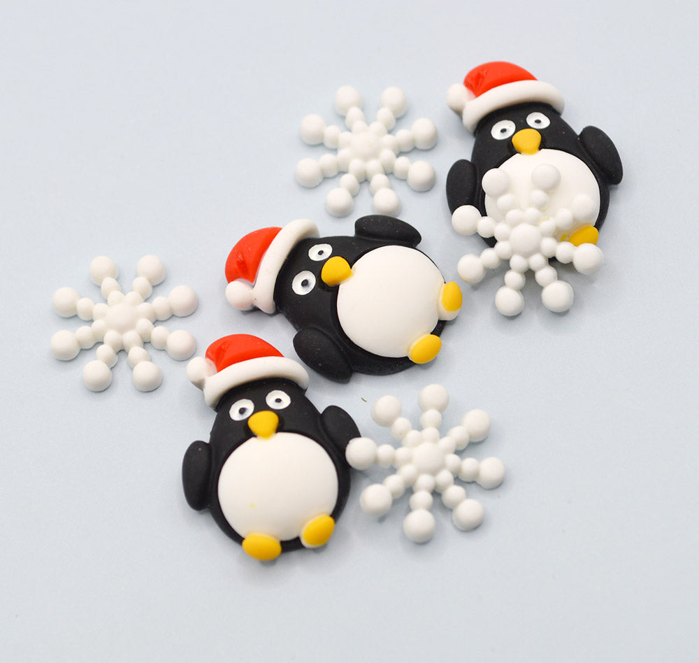 Decorative penguins with Santa hats and snowflakes on a light blue background