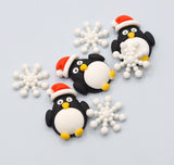 Decorative penguins with Santa hats and snowflakes on a light blue background