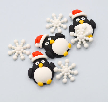 Decorative penguins with Santa hats and snowflakes on a light blue background