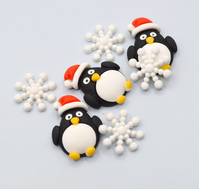 Decorative penguins with Santa hats and snowflakes on a light blue background