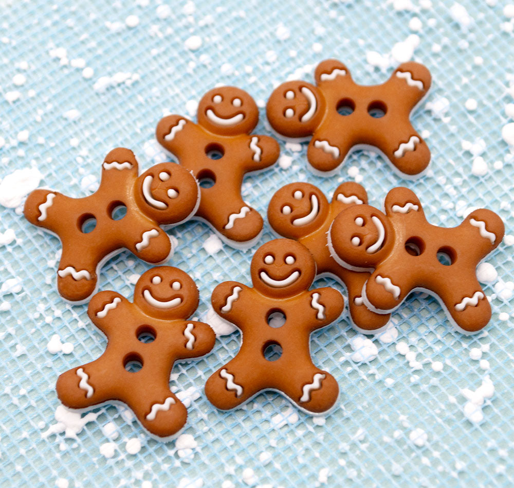 Gingerbread men cookies buttons with smiling faces on a blue background