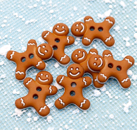 Gingerbread men cookies buttons with smiling faces on a blue background