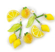 Two lemon-themed beaded jewelry charms on a white background, featuring yellow lemons, green leaves, green beads, and small white daisy flowers.