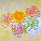 resin flower flat back flowers on a green background