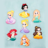 Seven small cartoon princess craft embellishments arranged on a light aqua background. The characters include Snow White, Cinderella, Rapunzel, Ariel, Belle, and Jasmine, each shown in a different colorful dress.