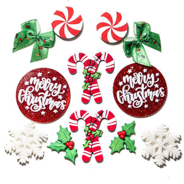 Collection of Christmas-themed embellishments including candy canes, holly leaves, and 'Merry Christmas' ornaments on a white background.