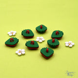 a shank-back button pack of strawberries and strawberry blossoms for spring crafting