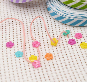 small 2-hole sewing buttons in the shape of flowers for DIY crafting