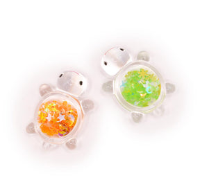 resin sequin filled clear turtle embellishments for crafting. 