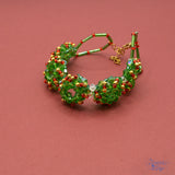  Featuring alloy enamel holly leaves and vibrant red and green accents