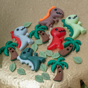 This themed pack includes resin T. rexes in natural earthy tones, along with tiny leaves and miniature palm trees