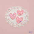 Pink flat-back resin hearts with iridescent flakes 
